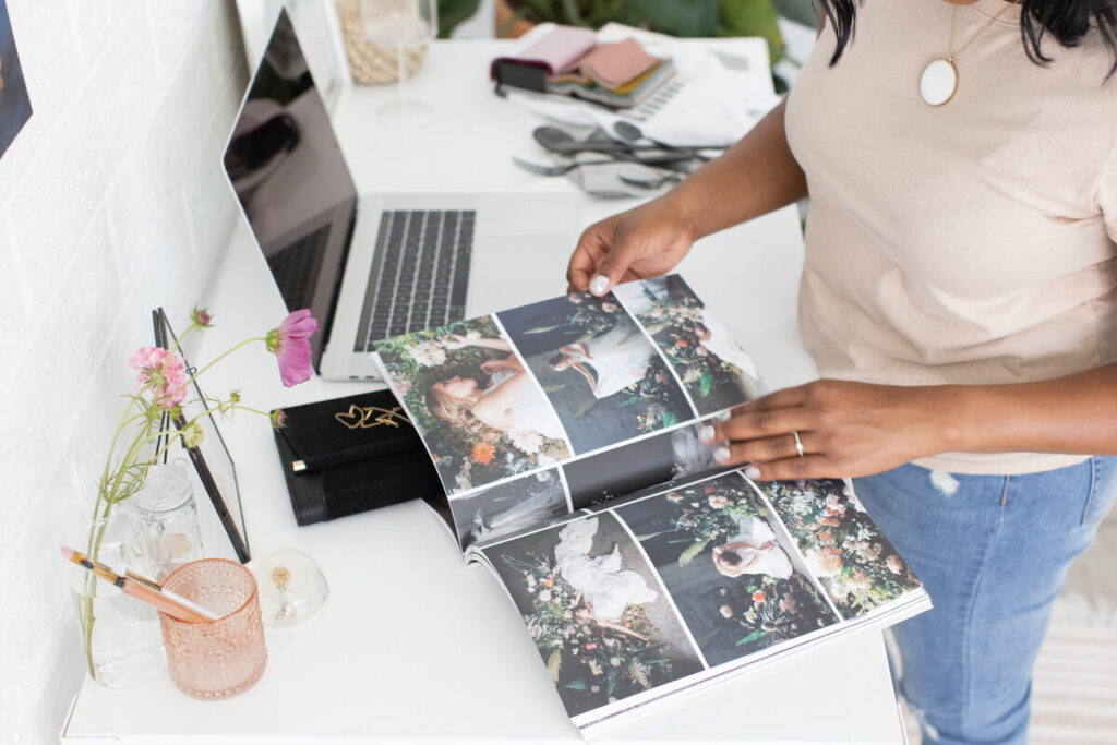 An overhead shot of someone holding a book with wedding images.