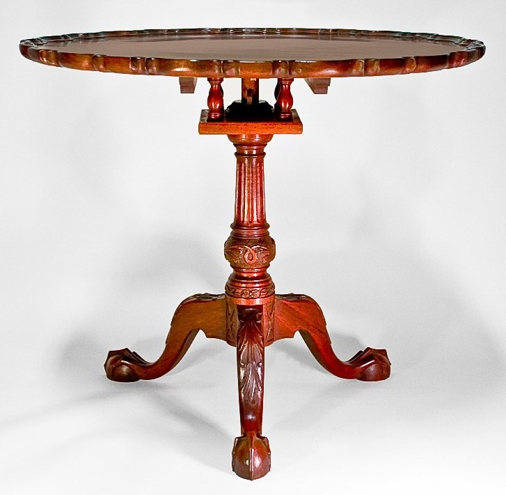 A finely detailed, small wooden table.