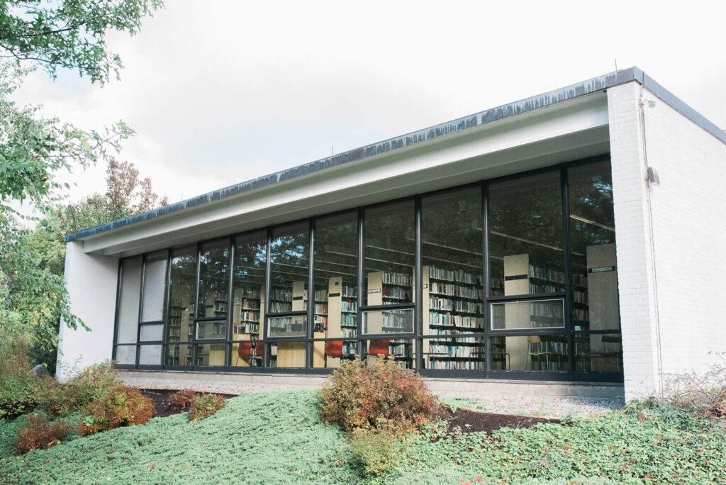 A modern library, windows full of books.