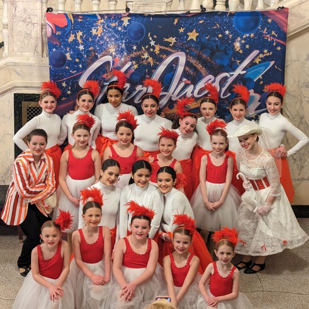 A group of young dancers posing together.